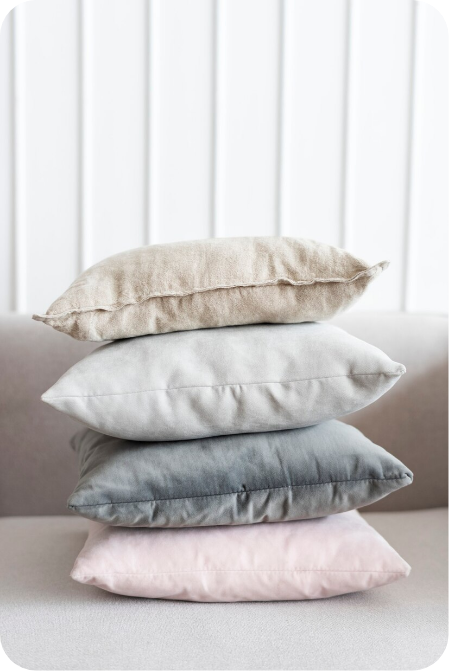 a stack of pillows on a couch