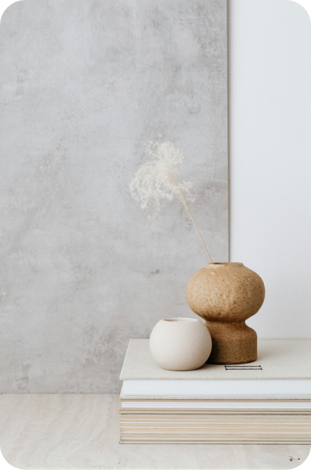 a vase with a feather in it