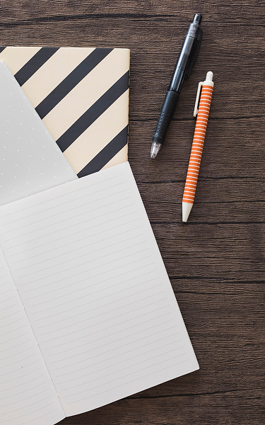 a notebook and pen on a table