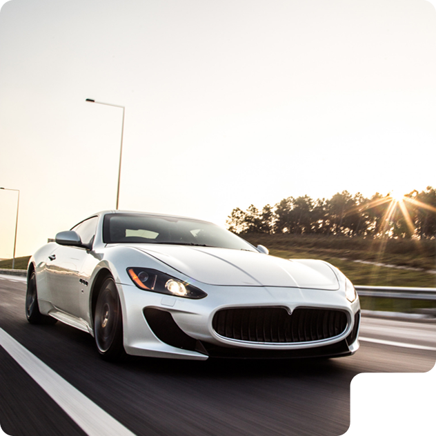 a white car driving on a road