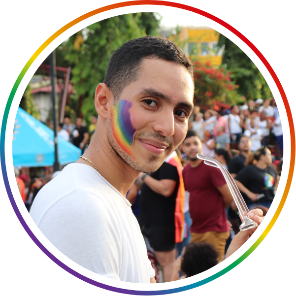 a man with rainbow face paint smiling