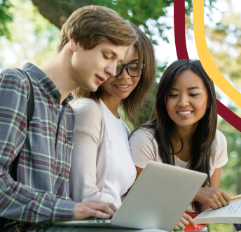 a group of people looking at a laptop