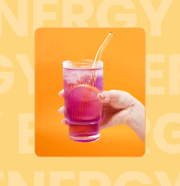 a hand holding a glass with a straw