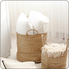 a basket with pillows and a blanket