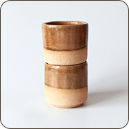 a stack of brown and white ceramic cups