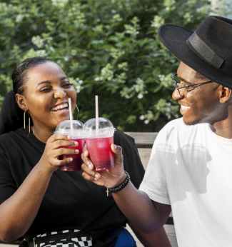 a man and woman holding drinks