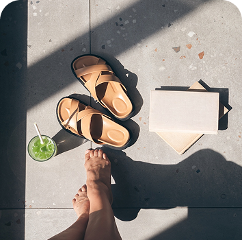 a pair of feet and sandals on a floor