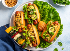 a plate of vegan hot dogs and vegetables