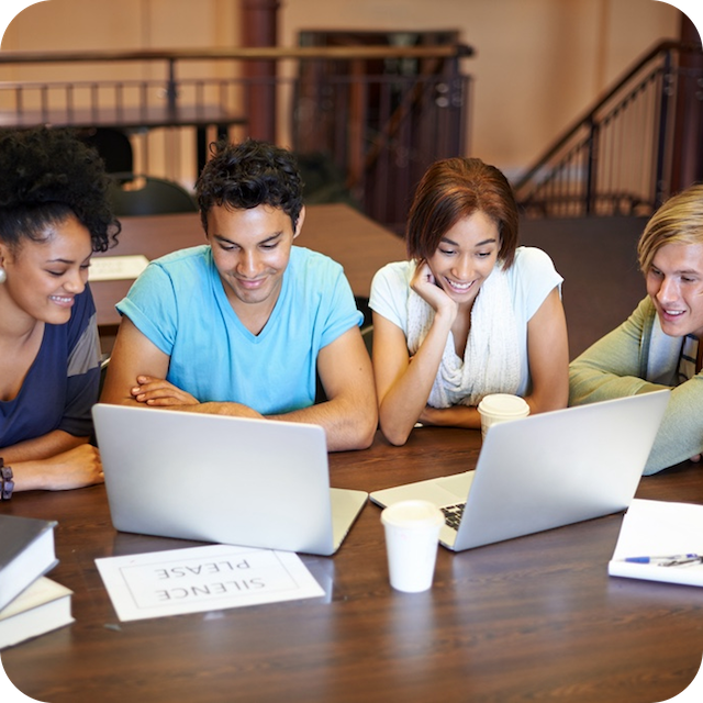 a group of people looking at a laptop