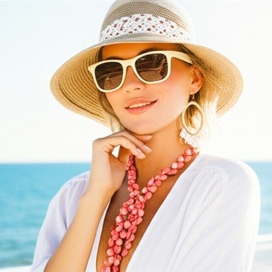 a woman wearing a hat and sunglasses