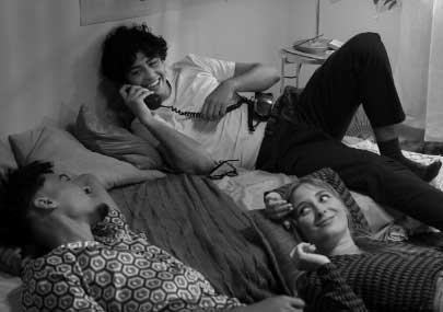 a group of people lying on a bed