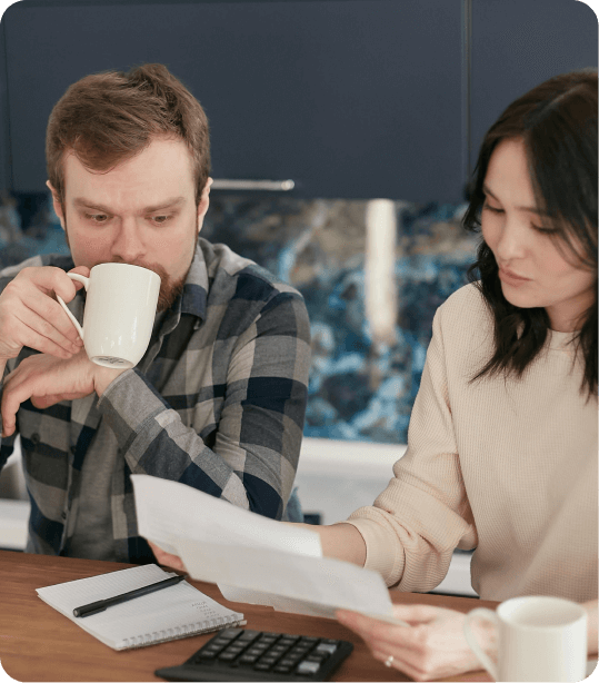a man and woman looking at papers