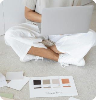 a person sitting on the floor with a laptop