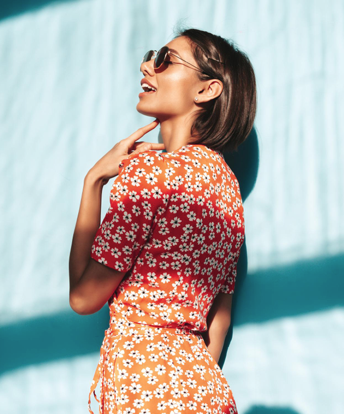 a woman in a dress and sunglasses