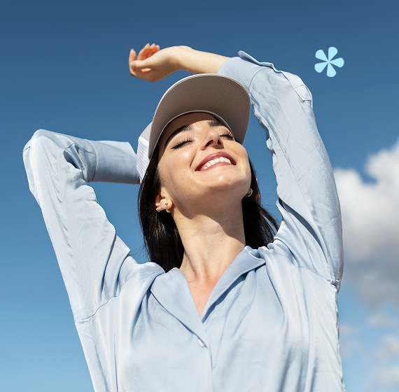 a woman with her arms raised and her eyes closed