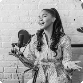 a woman speaking into a microphone