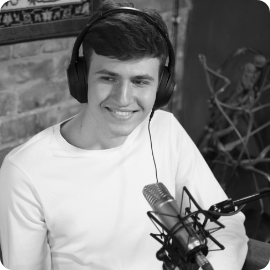 a man wearing headphones and sitting in front of a microphone