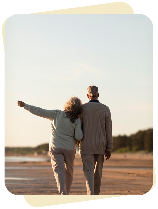 a man and woman walking on a beach